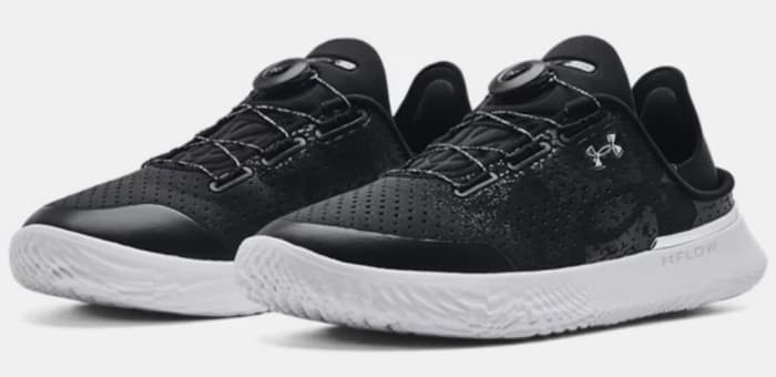 View of black and white Under Armour shoes.